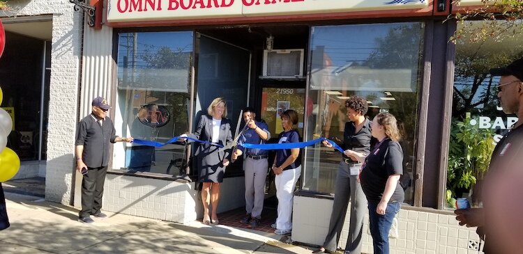 Jason Gardner celebrates the ribbon cutting with Mayor Kirsten Holzheimer Gail and other Euclidians.