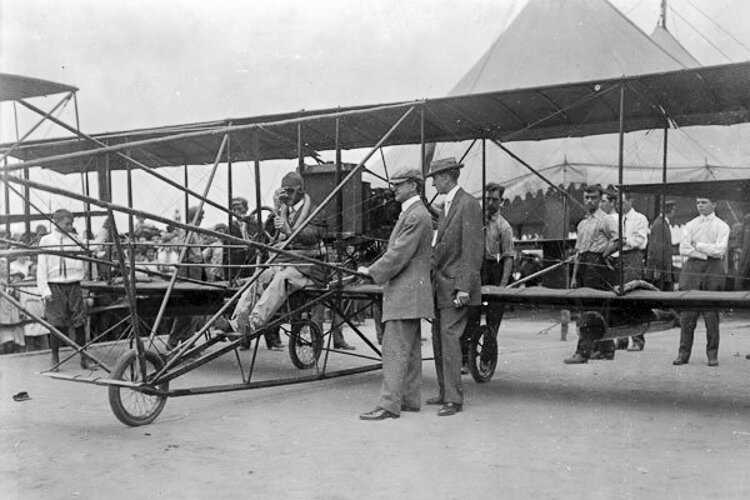 Glenn Curtiss sits in the cockpit of his plane as he prepares to depart Euclid Beach for Cedar Point on August 31, 1910.