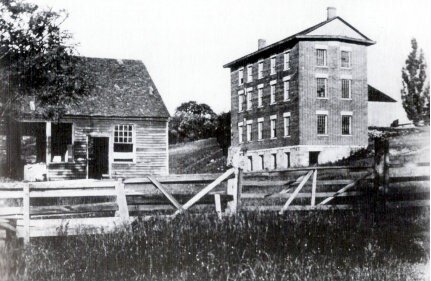 <span class="content-image-text">Shaker blacksmith shop (left) and woolen mill c. 1895</span>