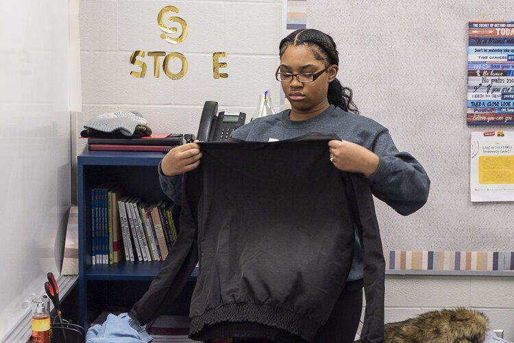 <span class="content-image-text">Smith and her team sort through the clothes to ensure there are no damages or stains</span>