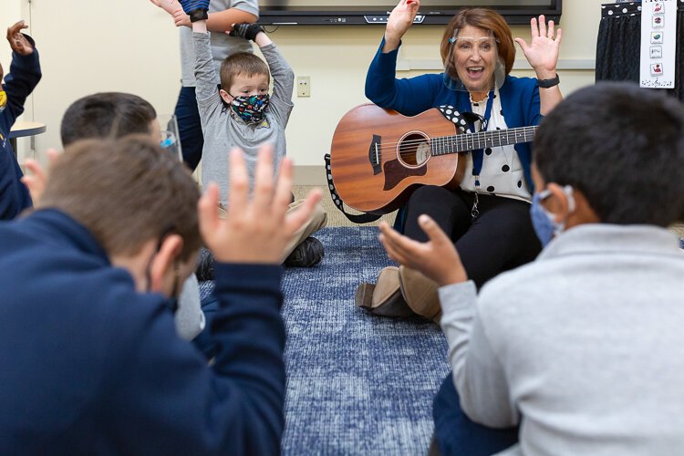 <span class="content-image-text">Lisa Ligus with guitar leading the 2nd graders in a music and movement activity at JB Schools Westlake.</span>