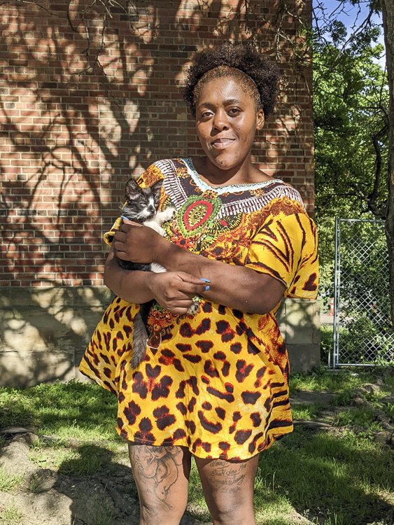 <span class="content-image-text">Tesia McDonald, a Central neighborhood resident, must walk at least 30 minutes to the nearest grocery store, a difficult task considering she’s shopping for her four children. She’s seen here with a kitten she’s raising.</span>