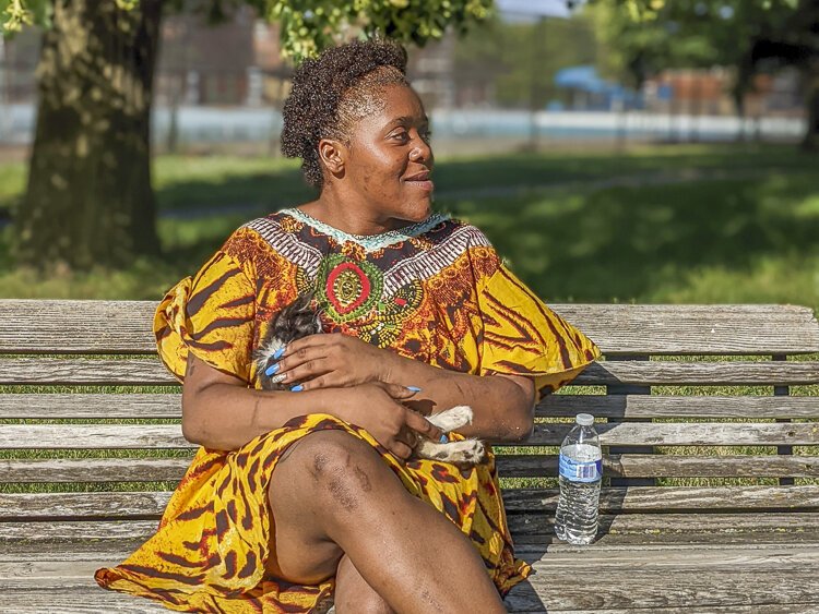 Tesia McDonald, a Central neighborhood resident, must walk at least 30 minutes to the nearest grocery store, a difficult task considering she’s shopping for her four children. She’s seen here with a kitten she’s raising.