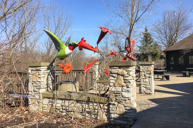 Colorful artwork nods to hummingbirds on the Center's back patio.