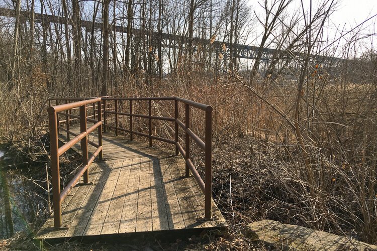 <span class="content-image-text">The Blue Heron Boardwalk with the CSX Short Line rail bridge looming in the background.</span>