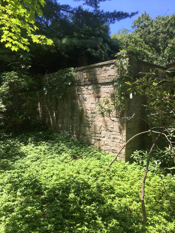 Stone retaining wall around a garden adjacent to the Francheste house