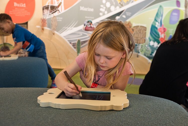 Children can draw their favorite animals at the sketching frames station.