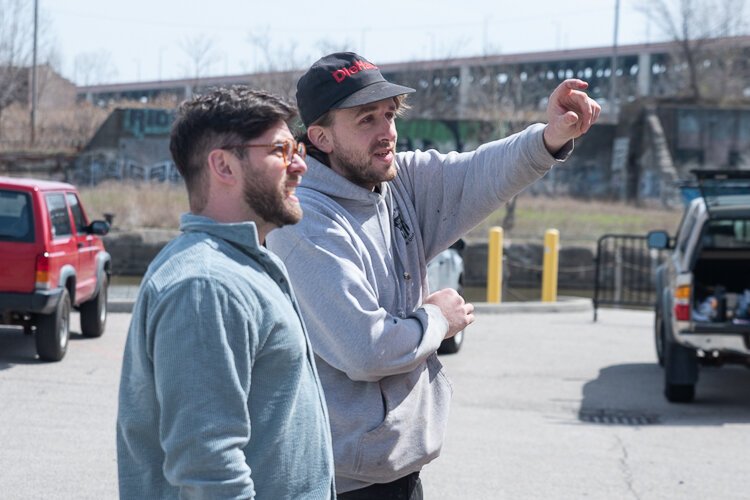 Detroit artist Pat Perry discusses his layout for the mural early on in the process with Joe Lanzilotta, project manager with LAND studio.