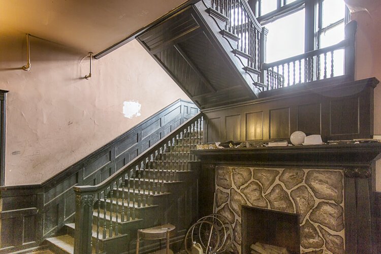 This 2015 photograph shows a grand staircase and beautiful fireplace on the first floor of the Allen-Sullivan House