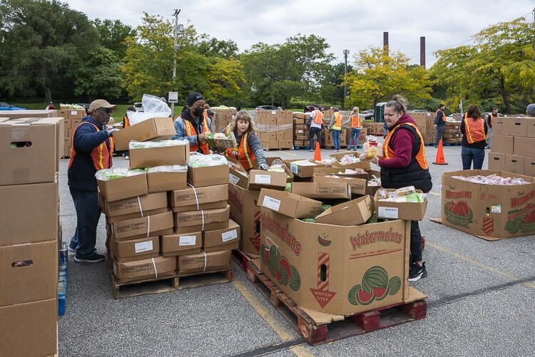Volunteers help distribute food at the Cleveland Food Bank Mobile Pantry Program at the City of Cleveland Muni Lot