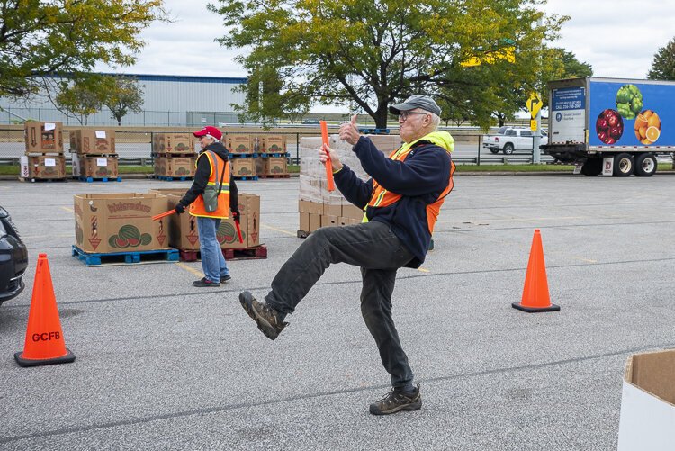 Greater Cleveland Food Bank volunteers crank up the music and have fun distributing food at the Cleveland Muni Lot