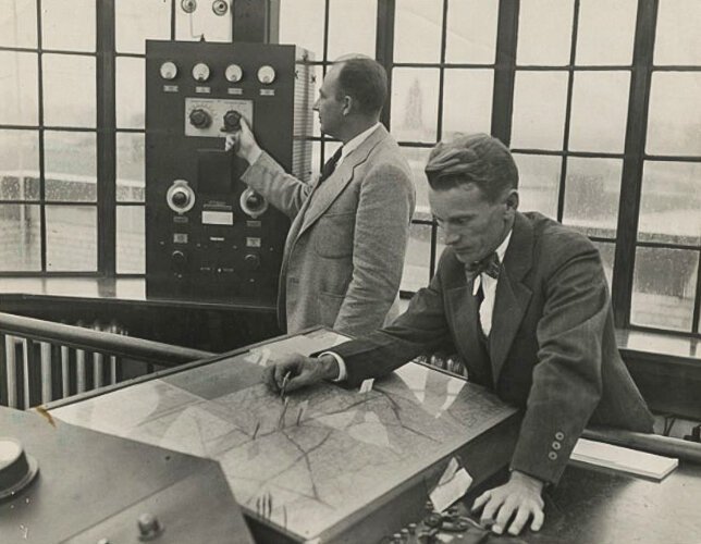 <span class="content-image-text">Two air traffic controllers at work plotting a map at Cleveland Municipal Airport 1930’s</span>