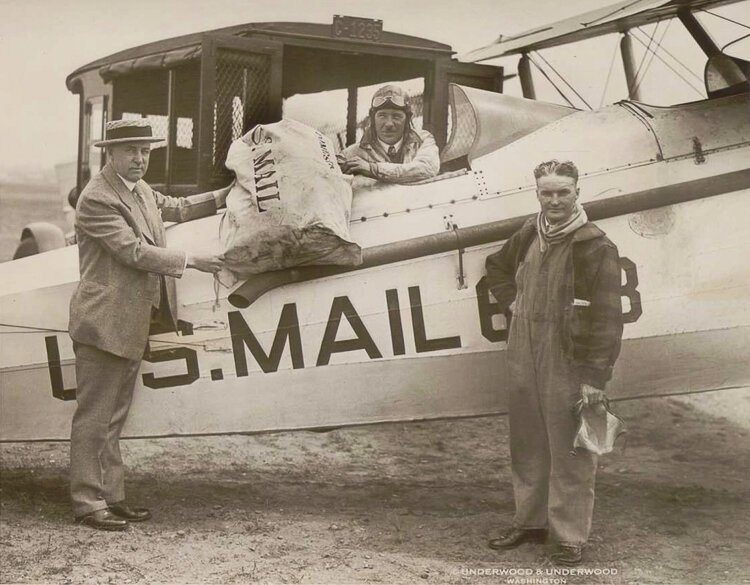 <span class="content-image-text">Airmail pilots Clevelander, Shirley J. Short (in plane), and Harry G. Smith on right on June 10, 1927.</span>