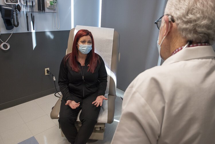 A Long Covid patient talks with UH COVID Recovery Clinic medical director David  Rosenberg at University Hospitals COVID Recovery Clinic in the Risman Pavilion