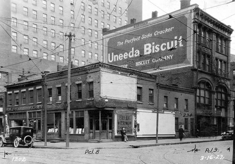 Northeast corner of Champlain St.. and West 3rd St. showing the former location of Kullmann's Restaurant, shoe repair shop and the former location of the C. A. Bresler Sons Co. - 1922