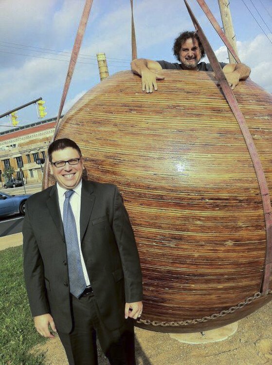 <span class="content-image-text">Artist Loren Naji inside his "They Have Landed" orb sculpture during its installation in 2011 with ex-councilman Joe Cimperman</span>