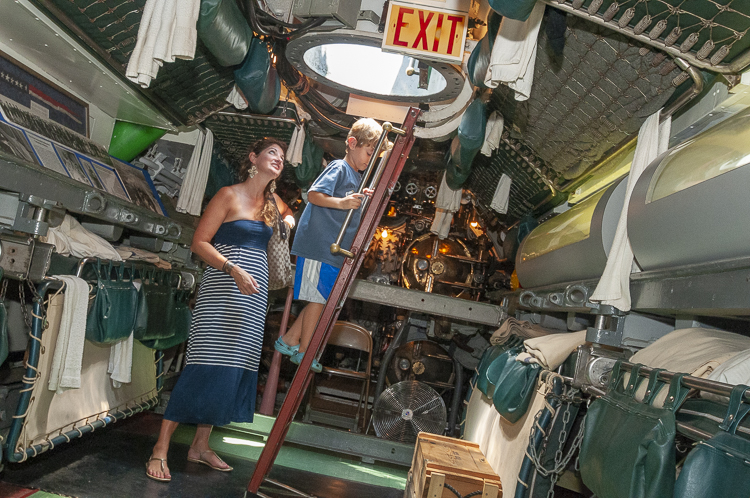 Going up the hatch in the USS Cod Submarine