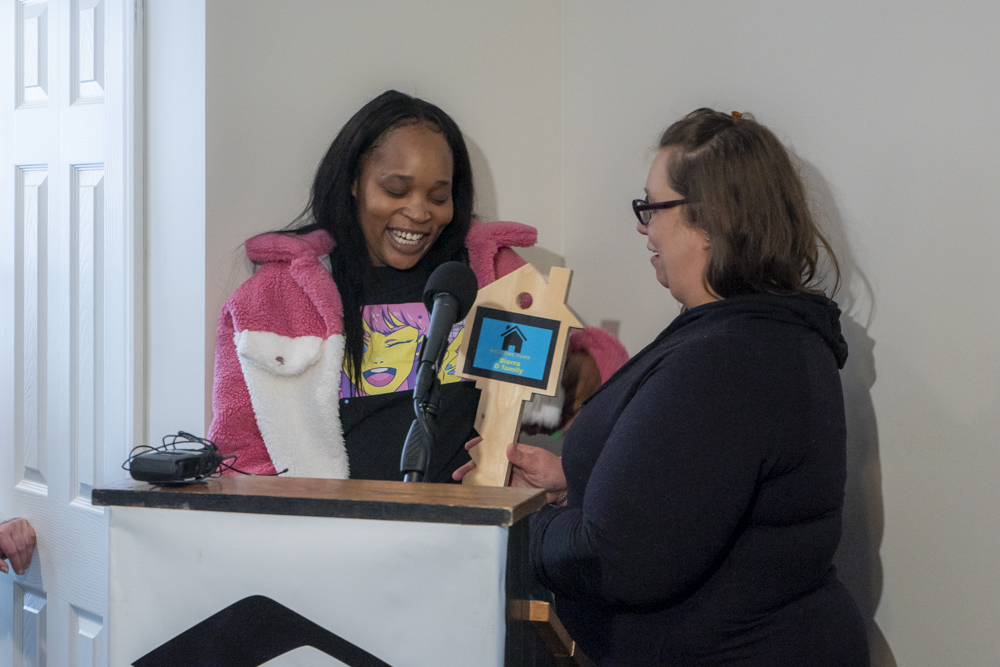 Jessica Morrison (right) – Greater Cleveland Habitat for Humanity, Associate Director of Family Programs presents new homeowner, Sierra with a symbolic key to her new home on Grandview Ave