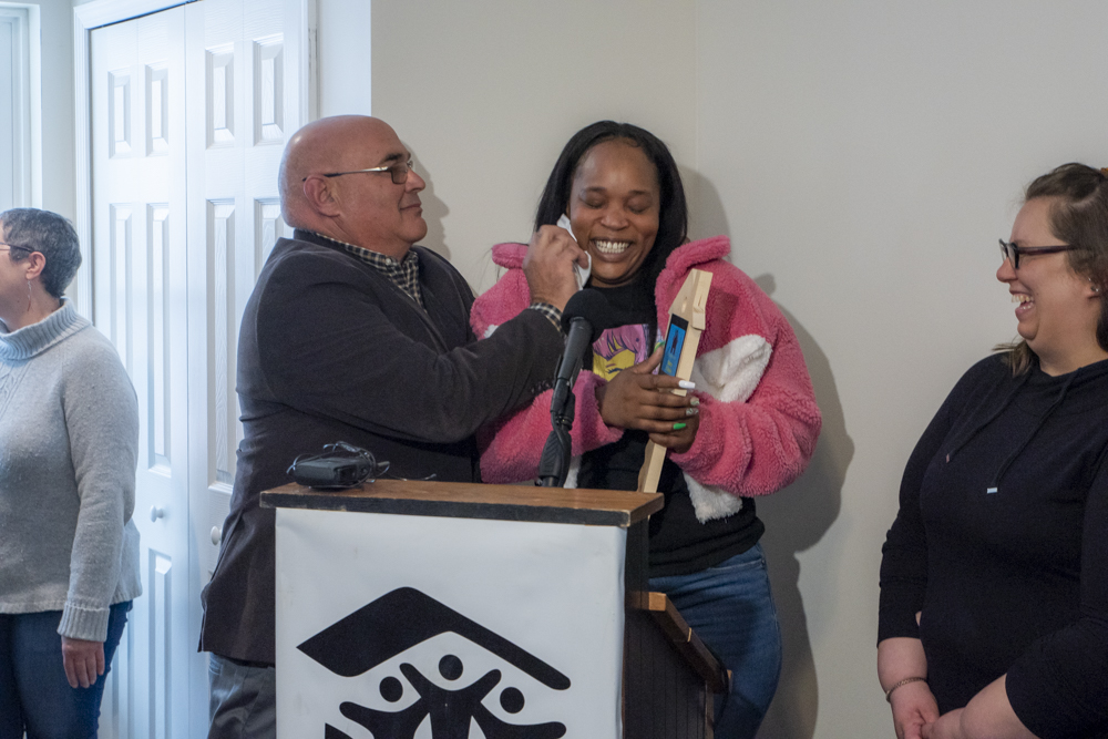 Tony DiGeronimo wipes tears from the eyes of new homeowner Sierra at the Habitat for Humanity Home Dedication Ceremony on Grandview Ave