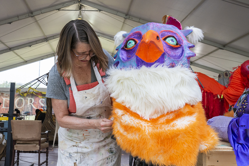 Guest artist Mary Joe Nikolai working on Marlin's Menagerie float for the Parade
