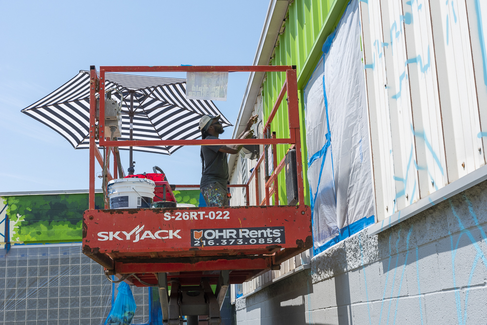 Isaiah Williams painting his Emerald Necklace mural