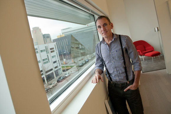 John Owens in his Uptown apartment with a great view of MOCA
