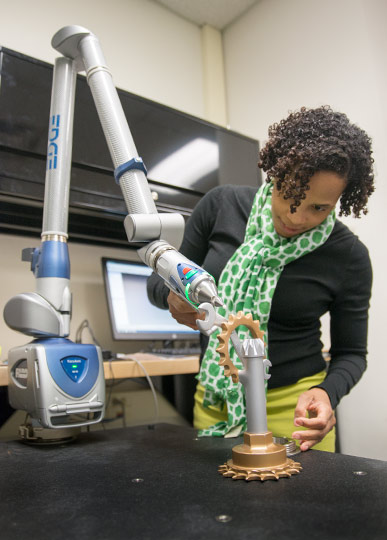 Alethea V. Ganaway, Career Coordinator at Tri-C demonstrates the 3D scanner