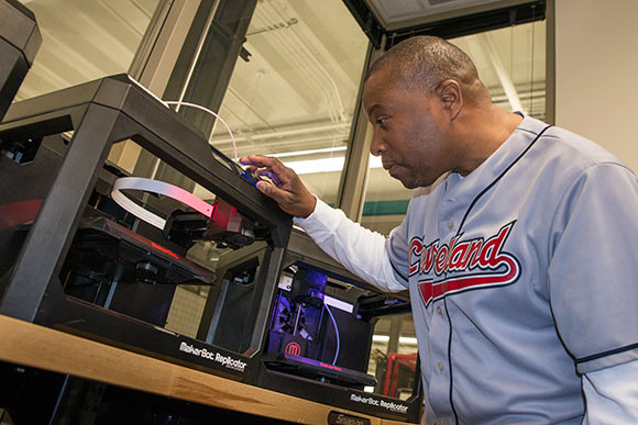 Student operating a 3-D printer at at Tri-C's Unified Technologies Center at Tri-C