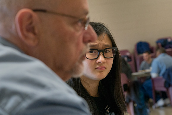 <span class="content-image-text">A CWRU students listens while an inmate discussus his life durring a breakout group</span>