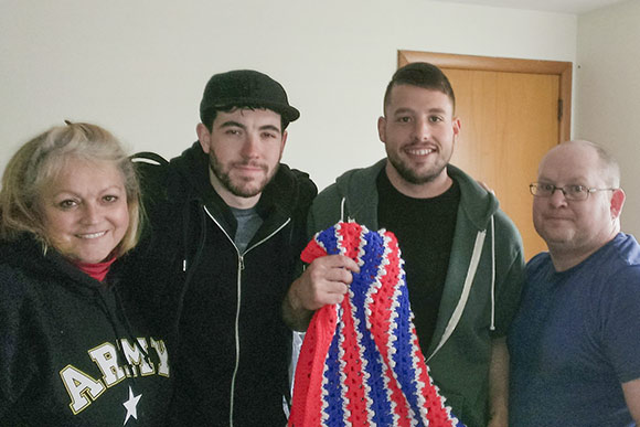 CAVA President Molly Carlin, volunteers Colton Rompala & Chuck Cox help Army veteran Ryan Perry with furniture & household items