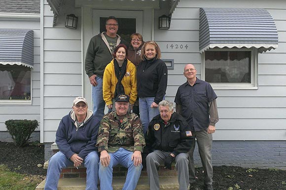 CAVA helped furnished a home purchased by this 17 year Veteran shown here (in yellow) with are volunteers from local VFW's & Veteran groups