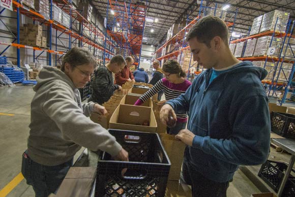 Volunteers at The Greater Cleveland Food Bank packing lunches for After School Programs