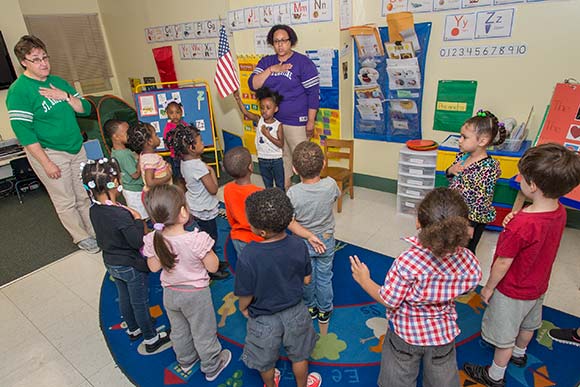 <span class="content-image-text">Students saying the The Pledge of Allegiance at St. Augustine Child Enrichment Center</span>
