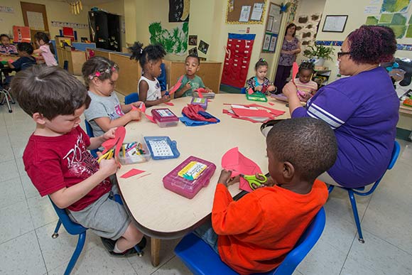 Teacher Anita Wilson working with Pre4CLE students at St. Augustine Child Enrichment Center