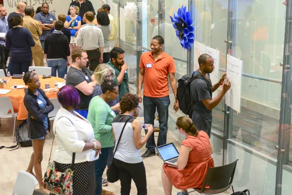 Taija Thomas of Hack4Baltimore overlooks a discussion group on solutions for breaking the poverty cy