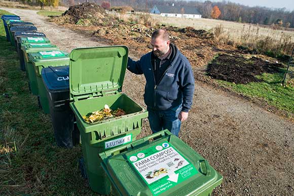 <span class="content-image-text">Chris Bond, Farm Horticulturist at CWRU Squire Valleevue Farm checks the waste brought in for composting</span>