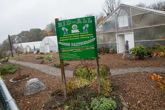 Rust Belt Riders collect fruit and vegetable trimmings for composting at the Rid-All Green Partnership, an urban farm in Cleveland's Kinsman neighborhood