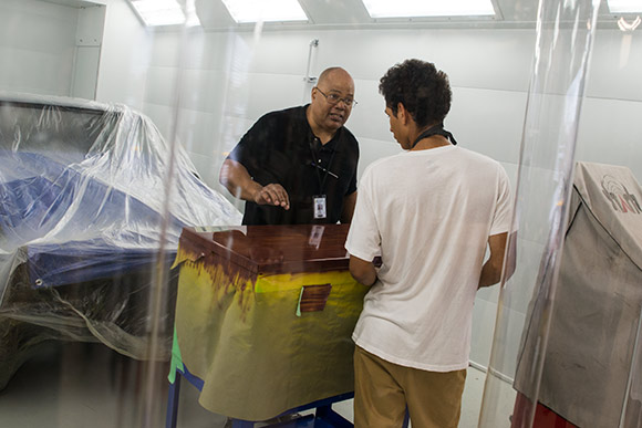 Max Hayes High School auto body repair class instructor Greg Boykin with student Jiquil Taylor