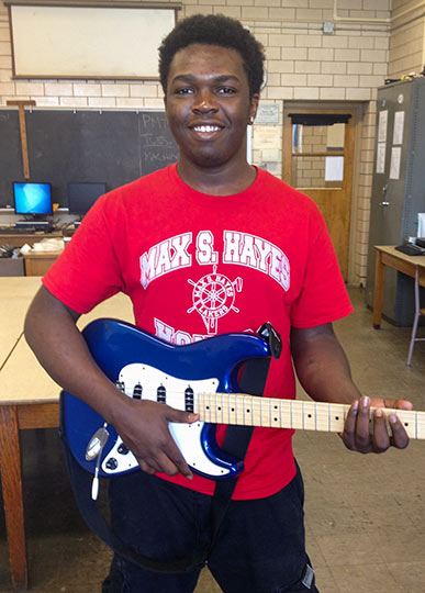 <span class="content-image-text">Max Hayes student playing the 1963 Fender Stratocaster made in the machine shop</span>