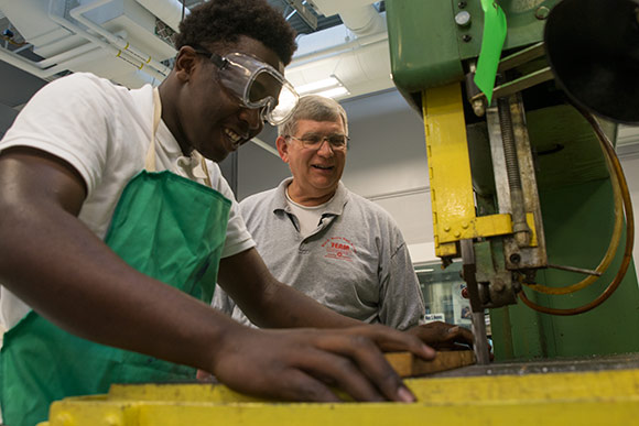 Max Hayes instructor Anthony Kazel, a 40-year veteran of the school's machine shop with student Devonta Edmonds