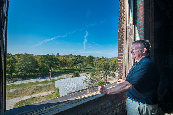 Developer J. Shorey looks out  at the neighborhood and city from the top floor of the Foundry Project bldg