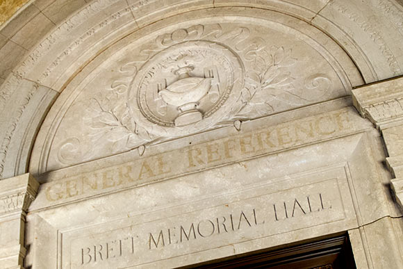 A lamp illuminating the way to more education, more wisdom, is emblematic of the library’s past and present