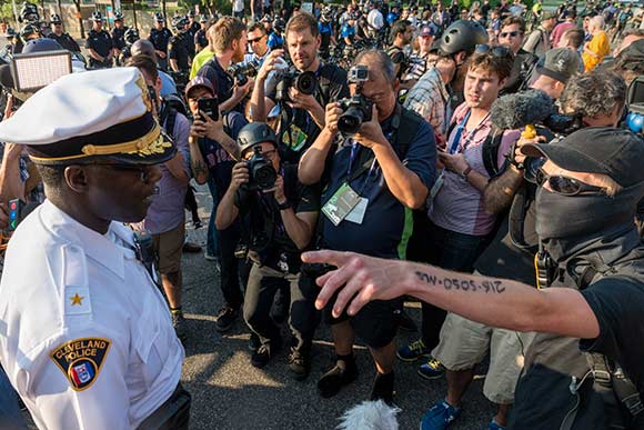 <span class="content-image-text">Police Chief Calvin Williams confronted by a masked protester</span>