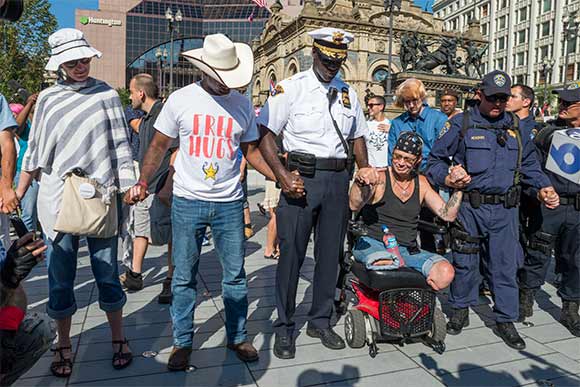 <span class="content-image-text">Police Chief Calvin Williams starts an impromptu peace prayer circle - looks like it worked!</span>