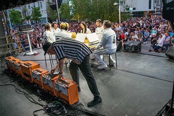 Mark Mothersbaugh, forefront, and the Music For Six Sided Keyboard concert at MOCCA