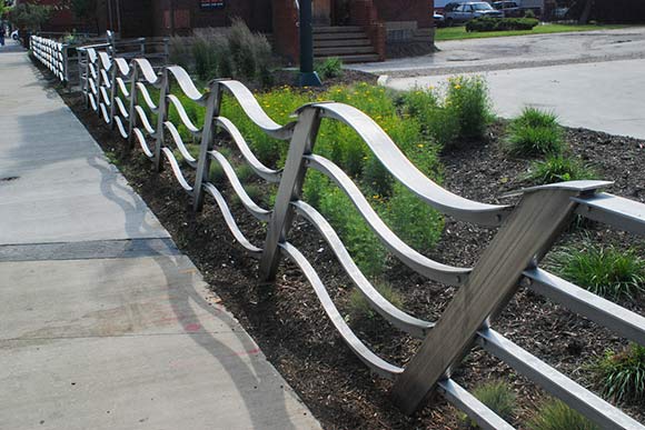 The Wave sculptural fence draws its form from the imagined wave vibrations of nearby Lake Erie