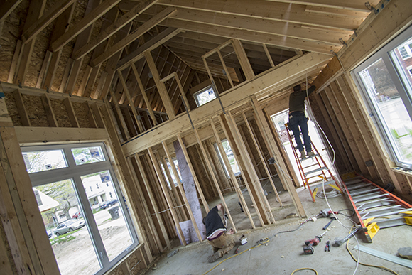 Electricians wiring up one of the homes in the Tiny House Experiment