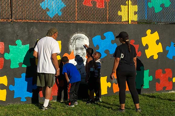 Volunteers putting the Chelton Park mural project pieces together