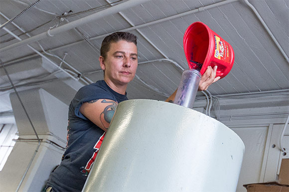 Heather Gmucs pouring vinyl flash into the record presser
