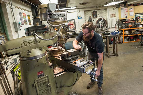 Alex uses equiptment from the 1900's to hand tool some of his parts